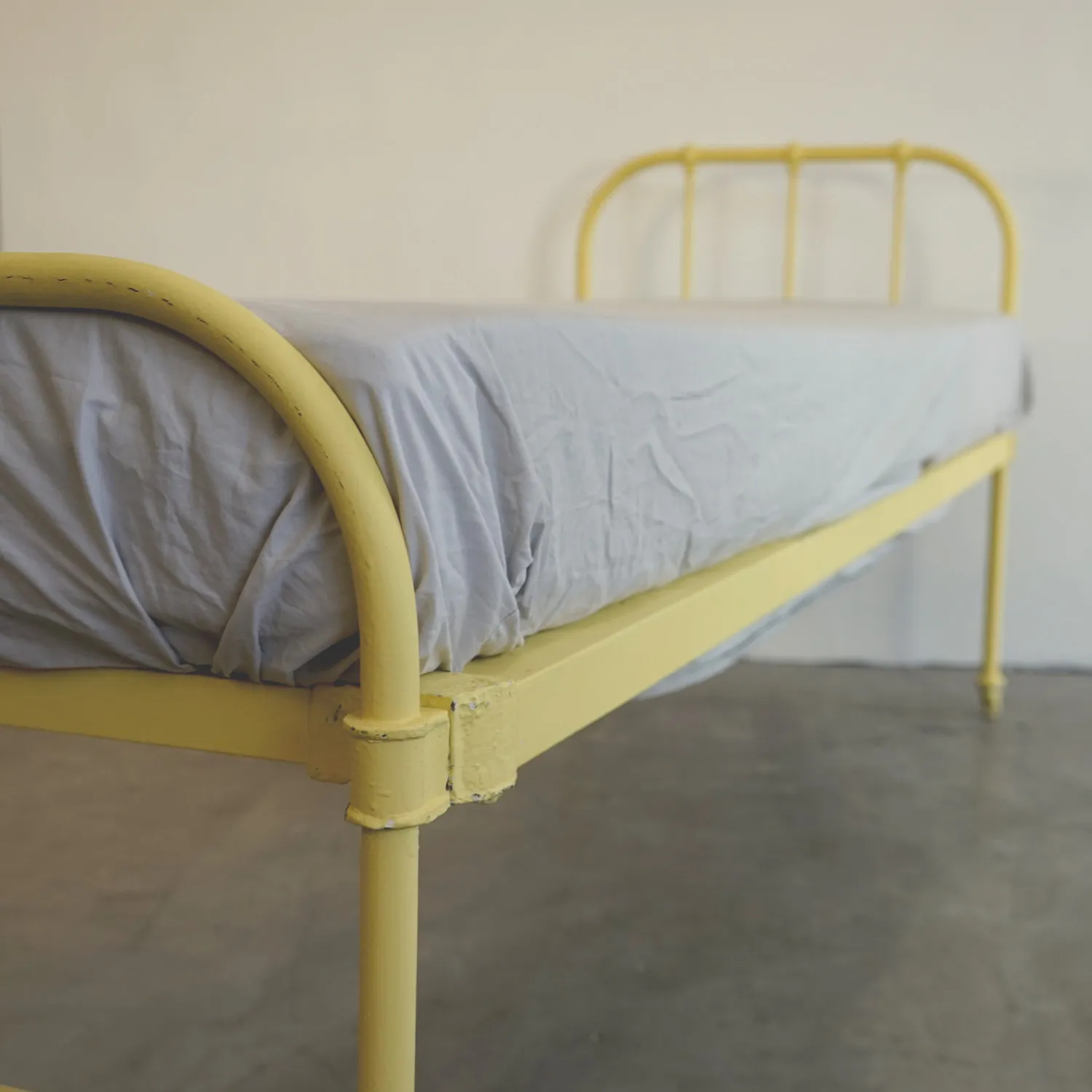Yellow metal frame single bed