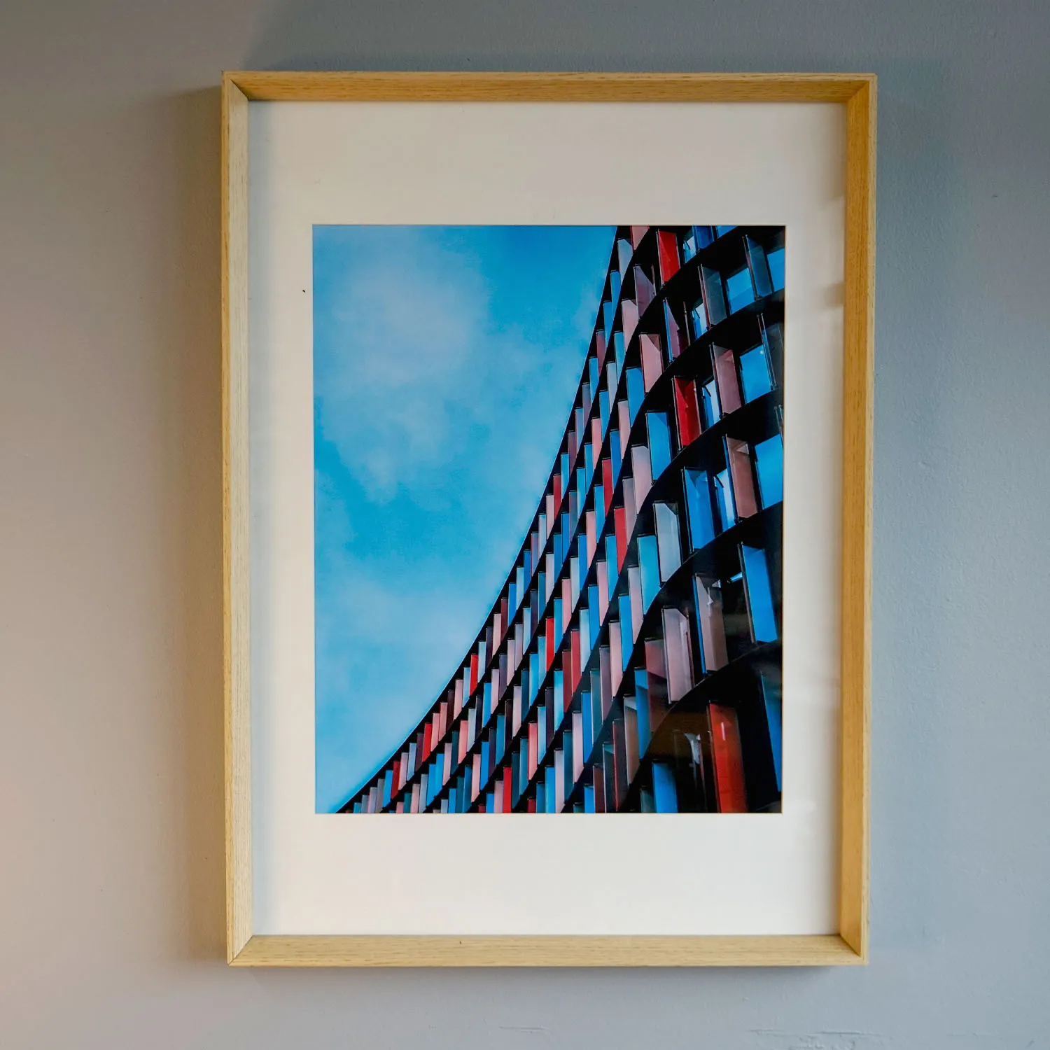 Blue and red architectural artwork on wooden frame