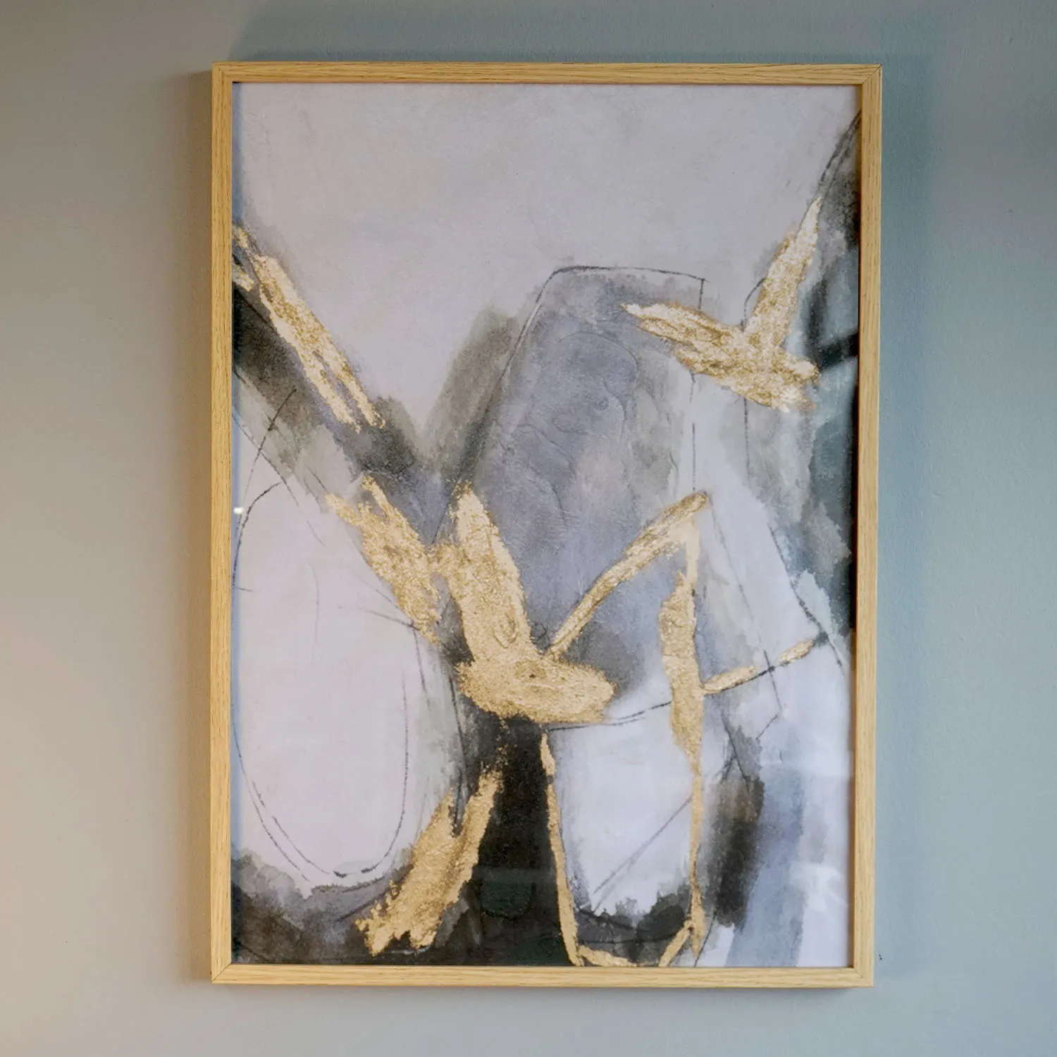 Abstract gold and grey artwork in wooden frame