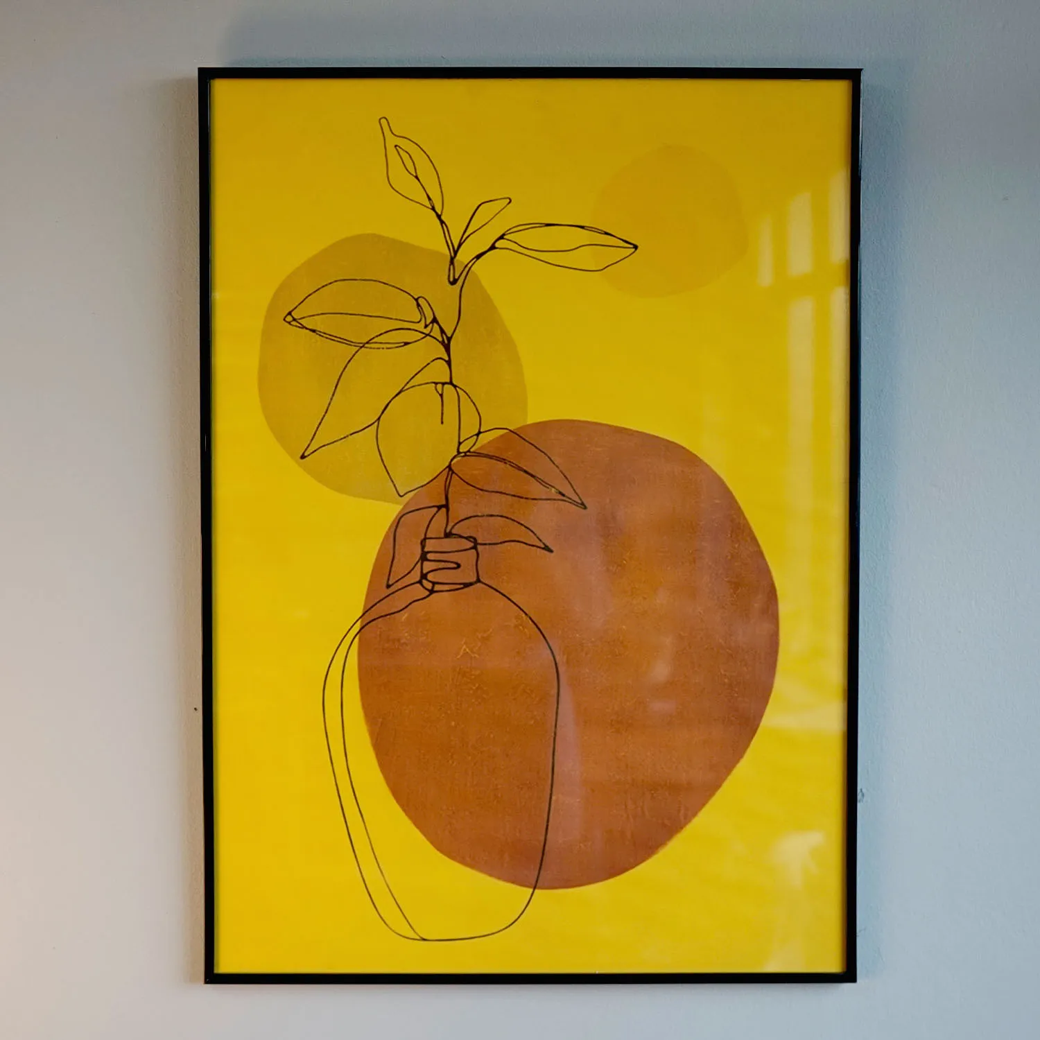 Yellow and orange abstract artwork with black frame