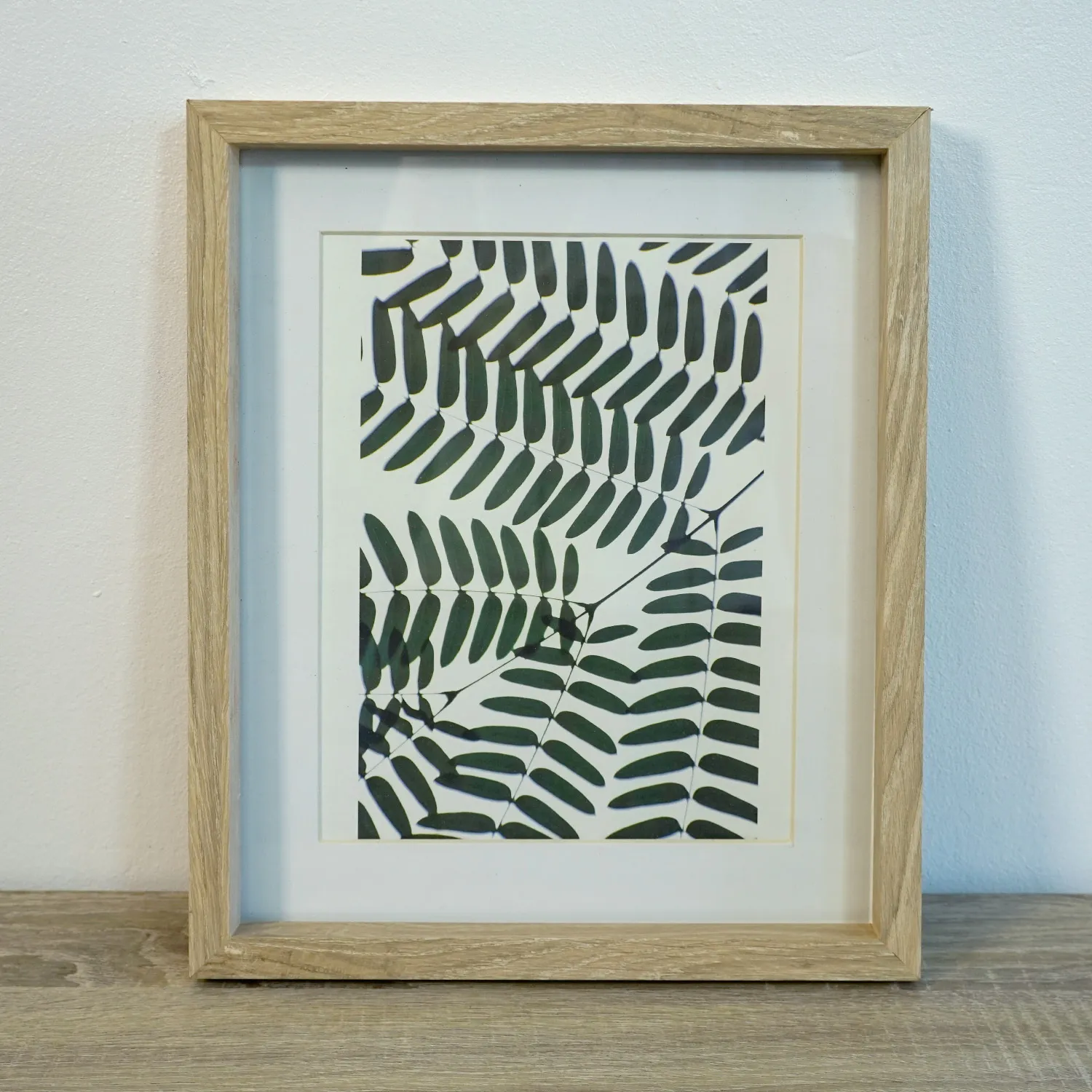 Small Light Wood Frame with green leaf royalty free artwork, glass cover
