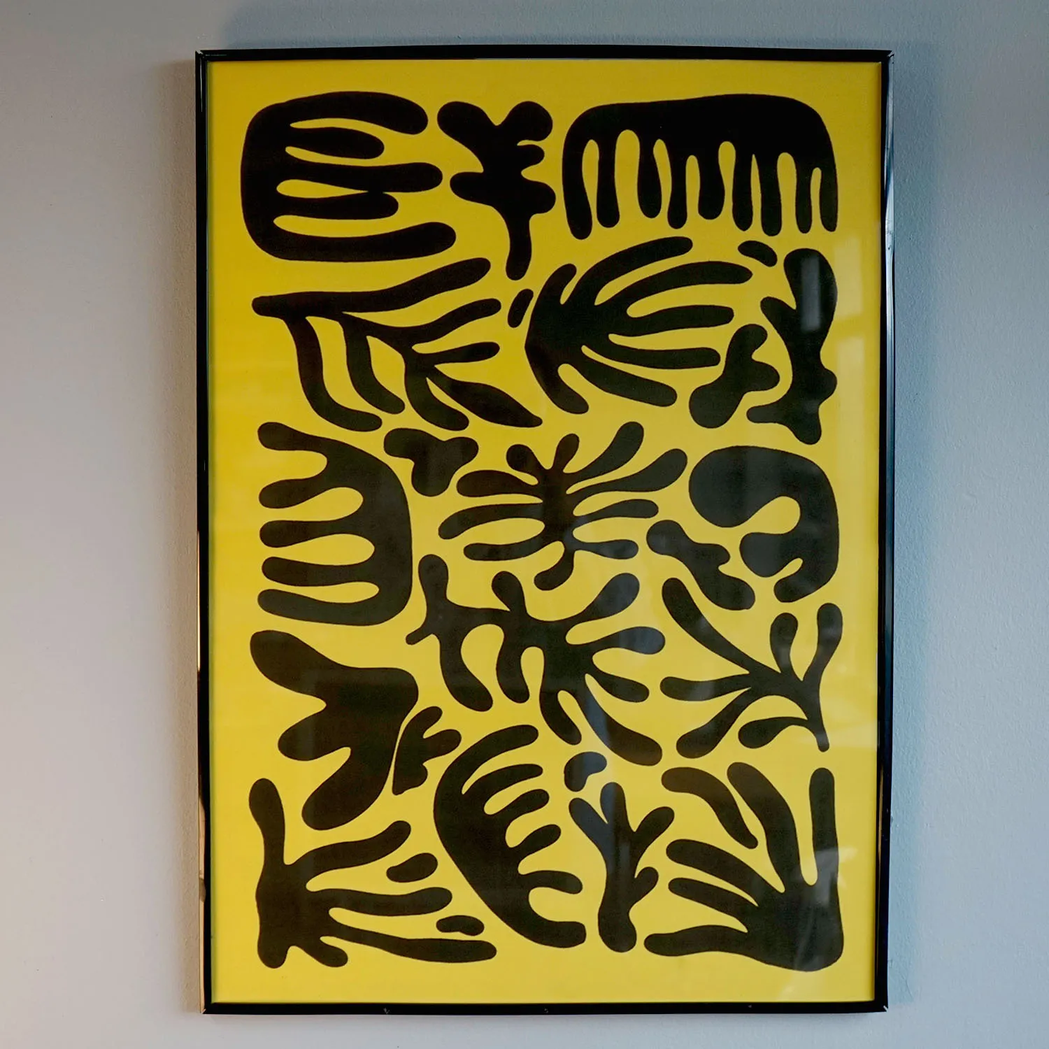 Yellow and black abstract artwork with black frame