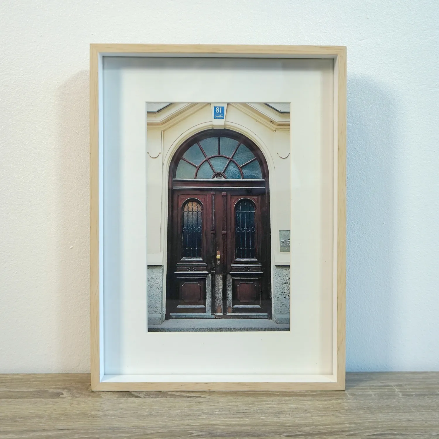 Light Wood Frame with Royalty red artwork of a Door in Munich, Glass cover