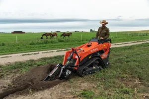 Kubota SCL 1000 Stand-on skid steer w/bucket (36'') & trencher (30'')