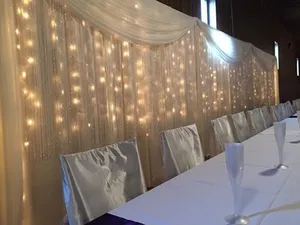 BACKDROP: Ivory drapery & lights 8'H
