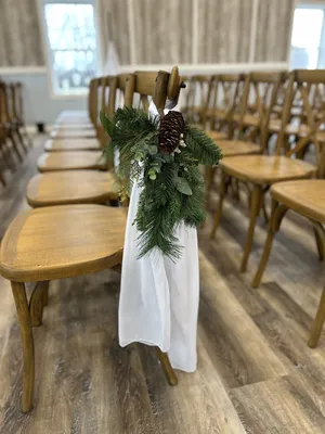 CHAIR/PEW DECOR: White chiffon & winter greenery