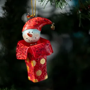 Snowman head with red sock cap on a spring. Jack in the box Christmas Tree Ornament. 