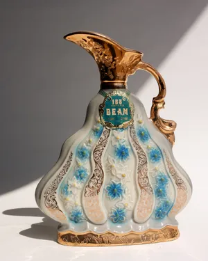 Vintage 1970 Ceramic Commemorative Jim Beam Decanter Blue, White, Gold with a handle and a spout 
