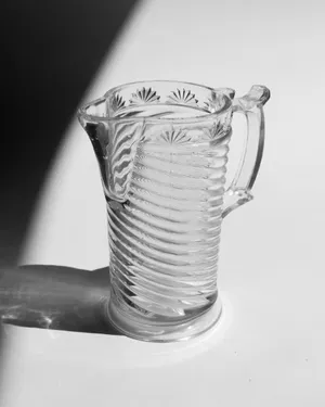 Clear Pressed Ribbed Medium Sized Milk Pitcher with a Handle and a Spout. Fleur De Lis