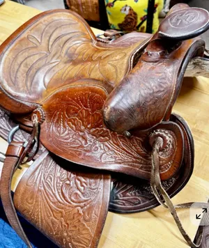 Vintage Brown Leather Horse Saddle with Stirrups. 