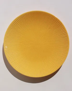 Bright Yellow Salad Plate with radical lines coming from a central point