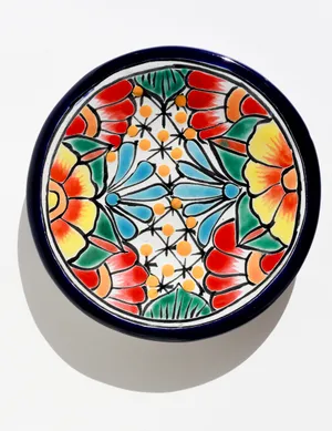 hand-painted Mexican Talavera pottery plate featuring vibrant floral designs
