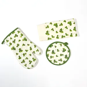 Cream with Green Shamrock Oven Mitt, quilted trivet, and dish towel with repeating green ivy plant print