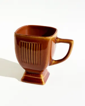 Stoneware Coffee Mug with a Unique Square Body, a Pedestal Base, light brown, caramel glaze.