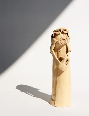 Cream Colored Ceramic Figurine From Saudi Arabia, bearded man wearing a keffiyeh holding a tea pot
