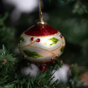 Red and Cream Glass Christmas bulb ornament with holly leaves