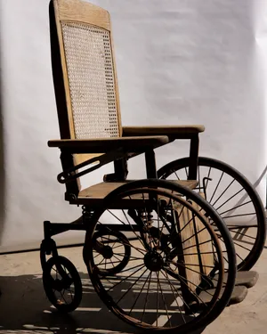Antique Oak and Wicker Wheel Chair. Old, Rusty, Spooky