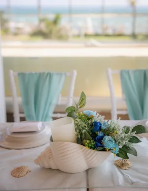 White Shell Vase with Pillar Candle and Flowers