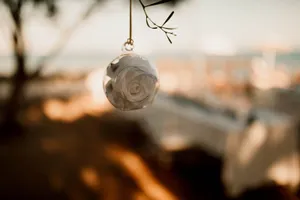 Hanging glass bauble with rose flower head