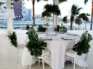 Tropical foliage arrangements for chairs/centrepieces