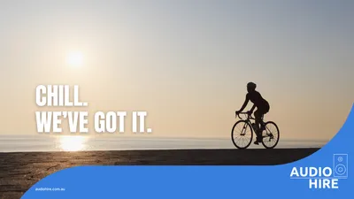 Cyclist on a beach at a Tour Down Under brand activation. Audio Hire.
