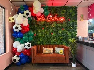 Soccer theme balloon decor installation at La Cubana Restaurant during World Cup celebrations in Kansas City Missouri