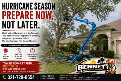 Towable boom lift rental used to trim dead tree branches near a home as part of hurricane season preparation in Brevard County, Florida