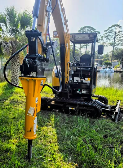 Mini excavator with hydraulic breaker attachment for concrete demolition in Santa Rosa Beach, Florida