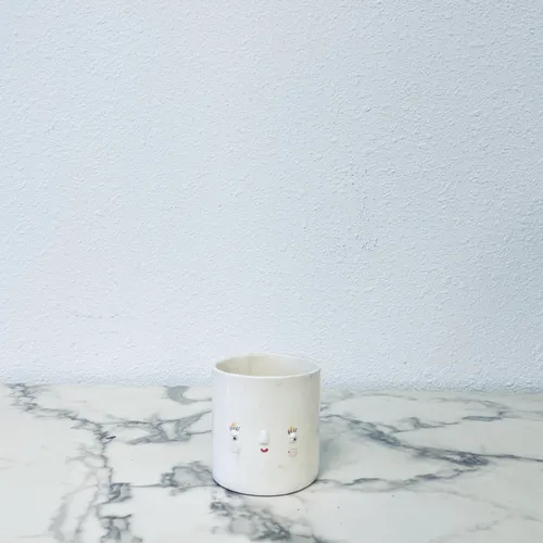 White ceramic face cup