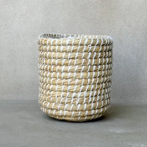 Natural Handwoven Seagrass planter basket with white detailing. 