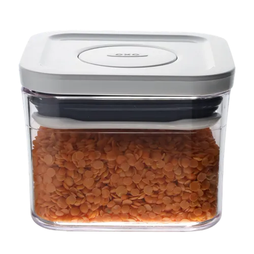 Clear Square Pop Top Low Profile Storage Container With White Lid Containing Orange Lentil