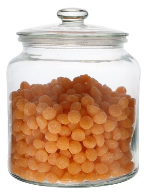 Clear Glass Canister With Lid Containing Orange Candy