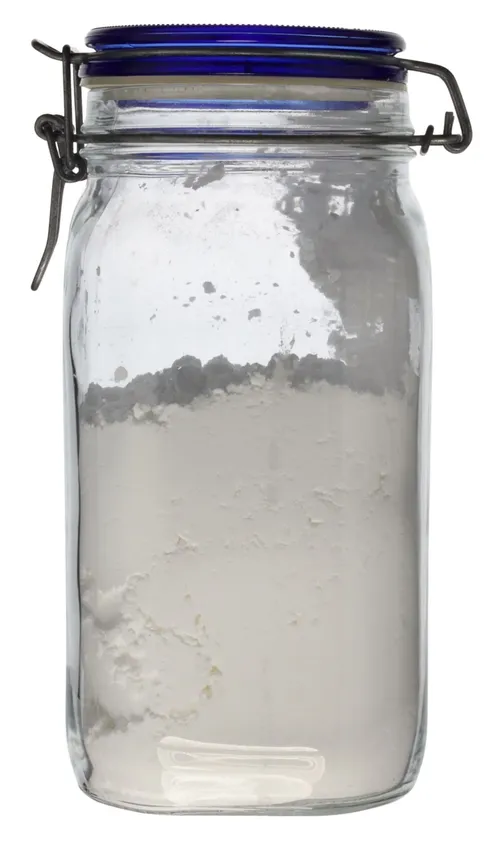 Clear Glass Canister With Blue Clamp Lid Containing Flour
