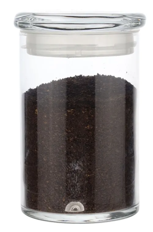 Clear Glass Canister With Lid Containing Ground Coffee