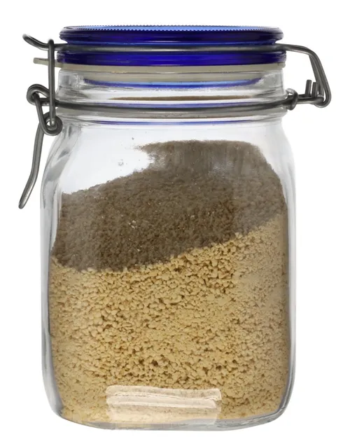 Clear Glass Canister With Blue Clamp Lid Containing Graham Crumbs