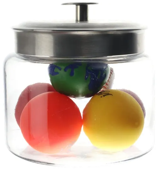 Clear Glass Container With Silver Lid Containing Assorted Balls