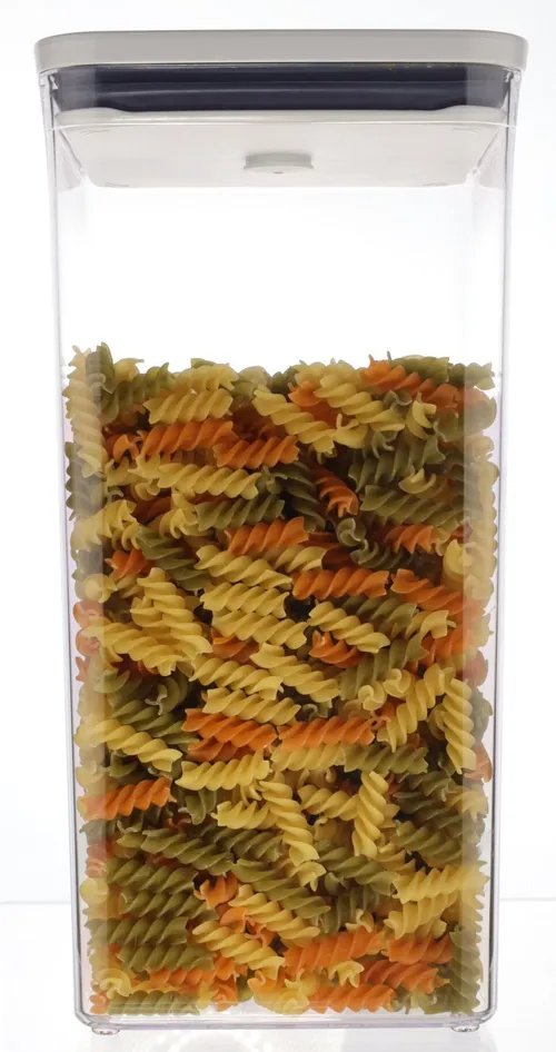 Clear Tall Rectangular Pop Top Low Profile Storage Container With White Lid Containing Pasta