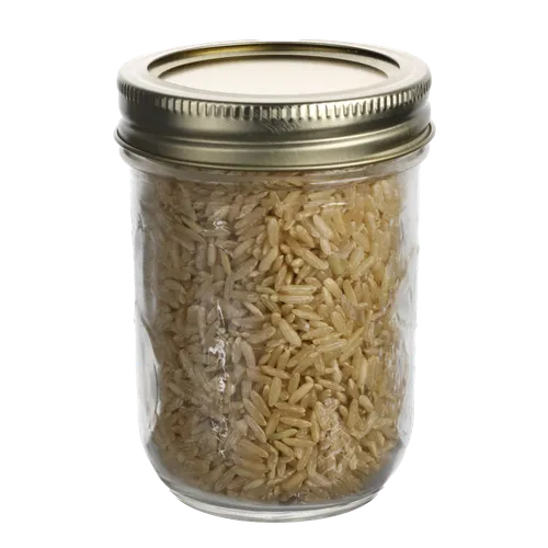 Small Clear Mason Jar With Tin Lid Containing Brown Rice
