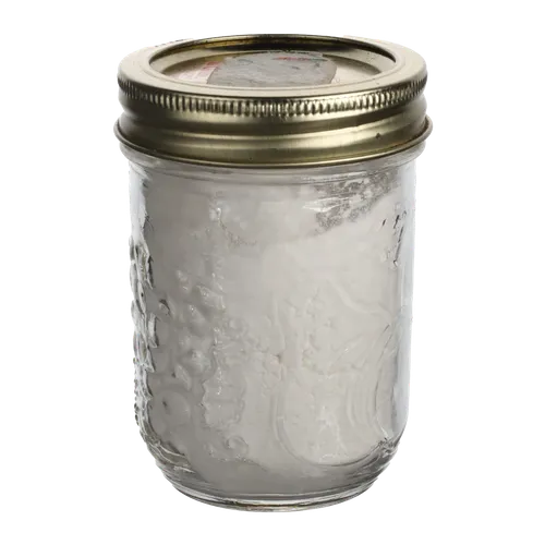 Small Clear Mason Jar With Tin Lid Containing Flour