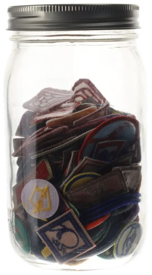 Clear Glass Jar Containing Badges