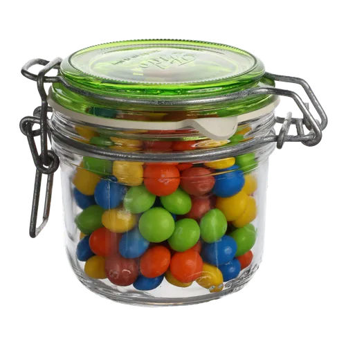 Clear Glass Jar With Green Lid Containing Candy
