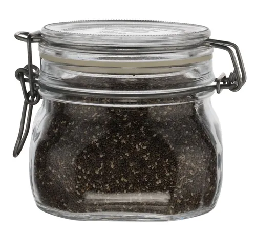 Clear Glass Canister With Hinged Lid Containing Seeds