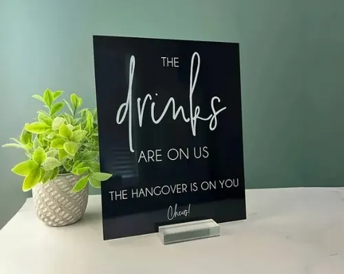 SIGN: Drinks are on us black sign