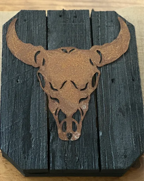 Small metal art on wood board