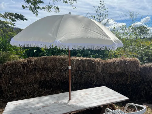 Beige umbrella with white frills