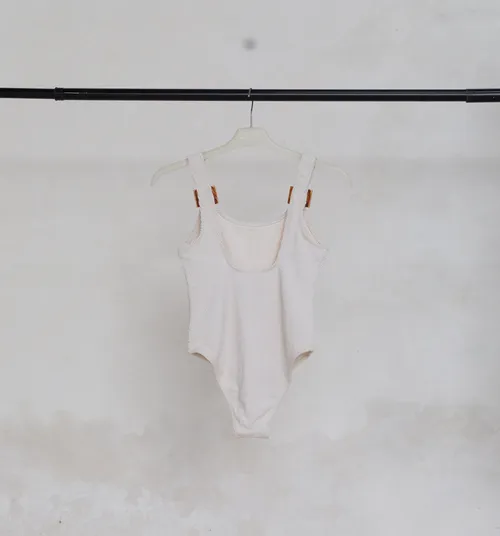 White Swimsuit with Brown Buckle Straps