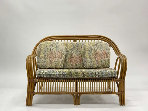 Wicker Loveseat with Pale Floral Cushions