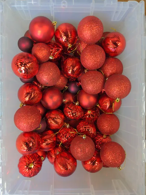 Bin of Assorted Red Ornaments