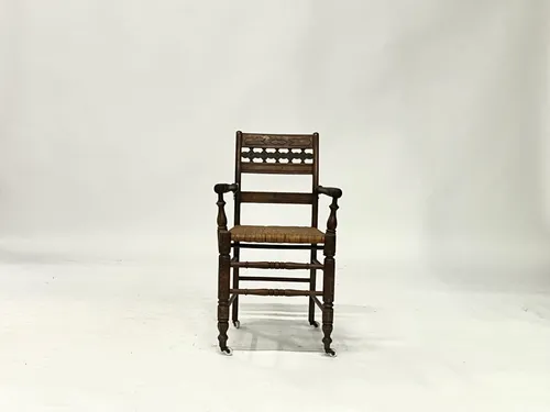 Antique Carved Wood & Woven Wicker Armchair on Casters
