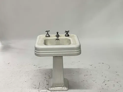 White Ceramic Pedestal Sink with Dark Silver Faucet